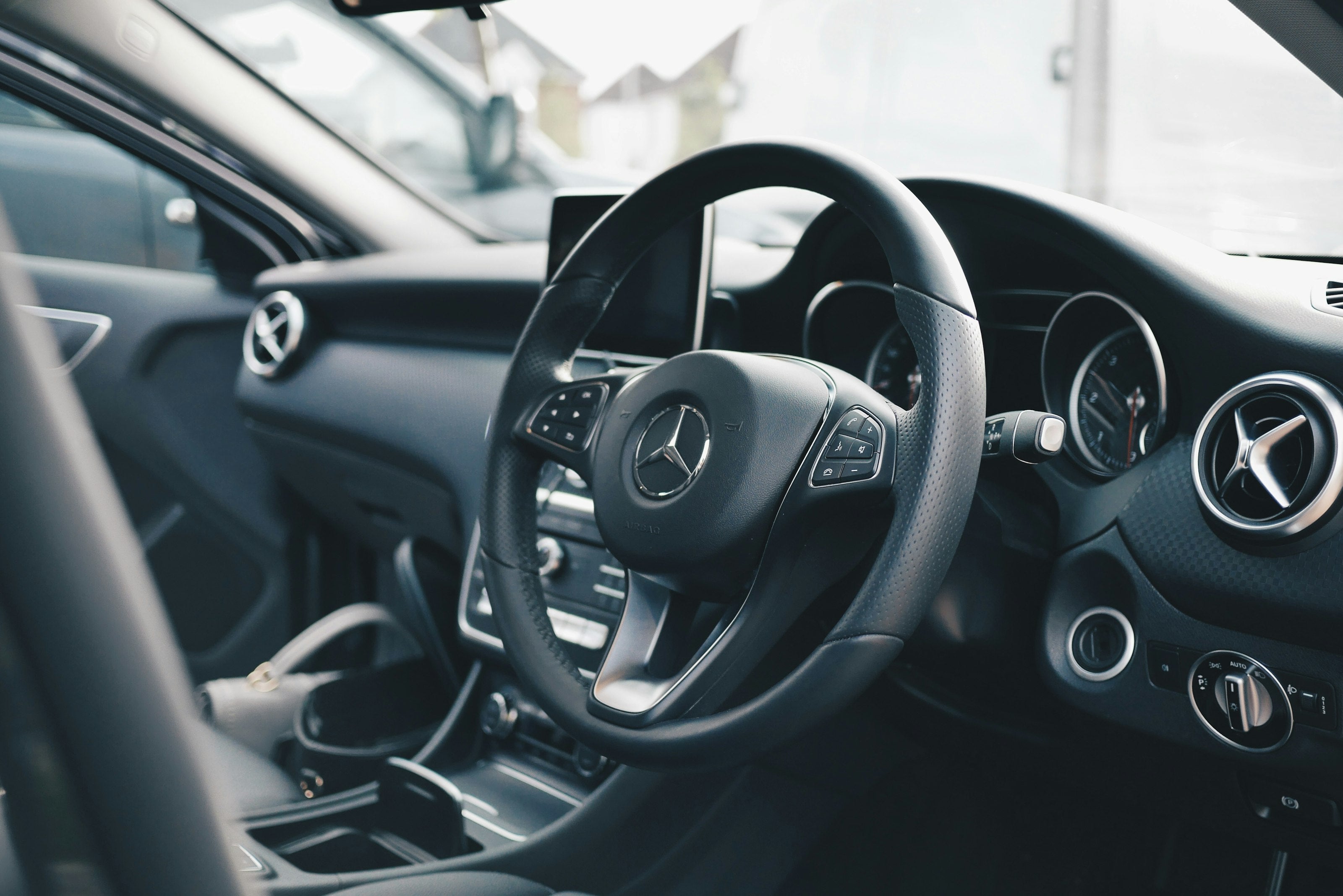 Black Mercedes interior at night with ambient glow - Aureon hero option